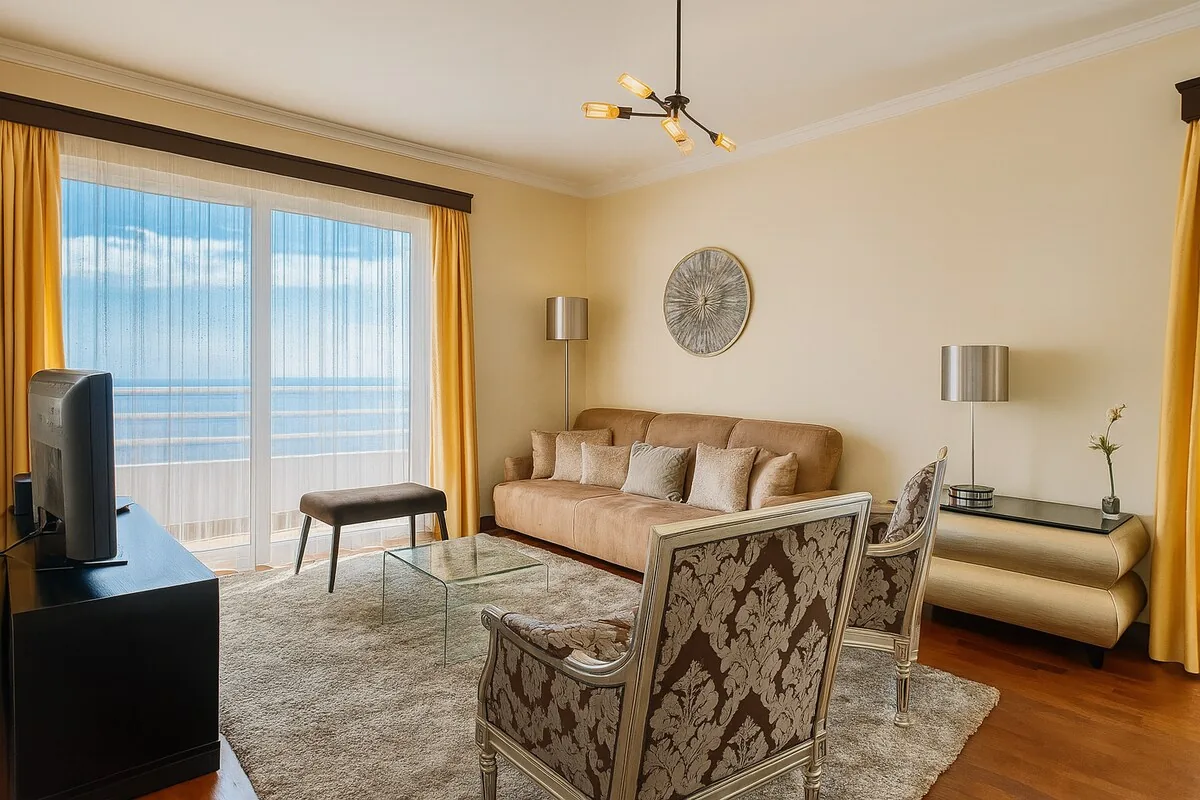 The living room, opening onto the balcony and the bay
